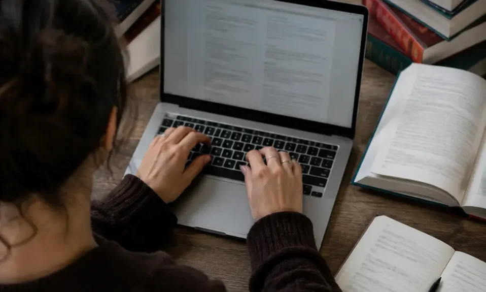 Multilingual writer typing accented letters on a laptop