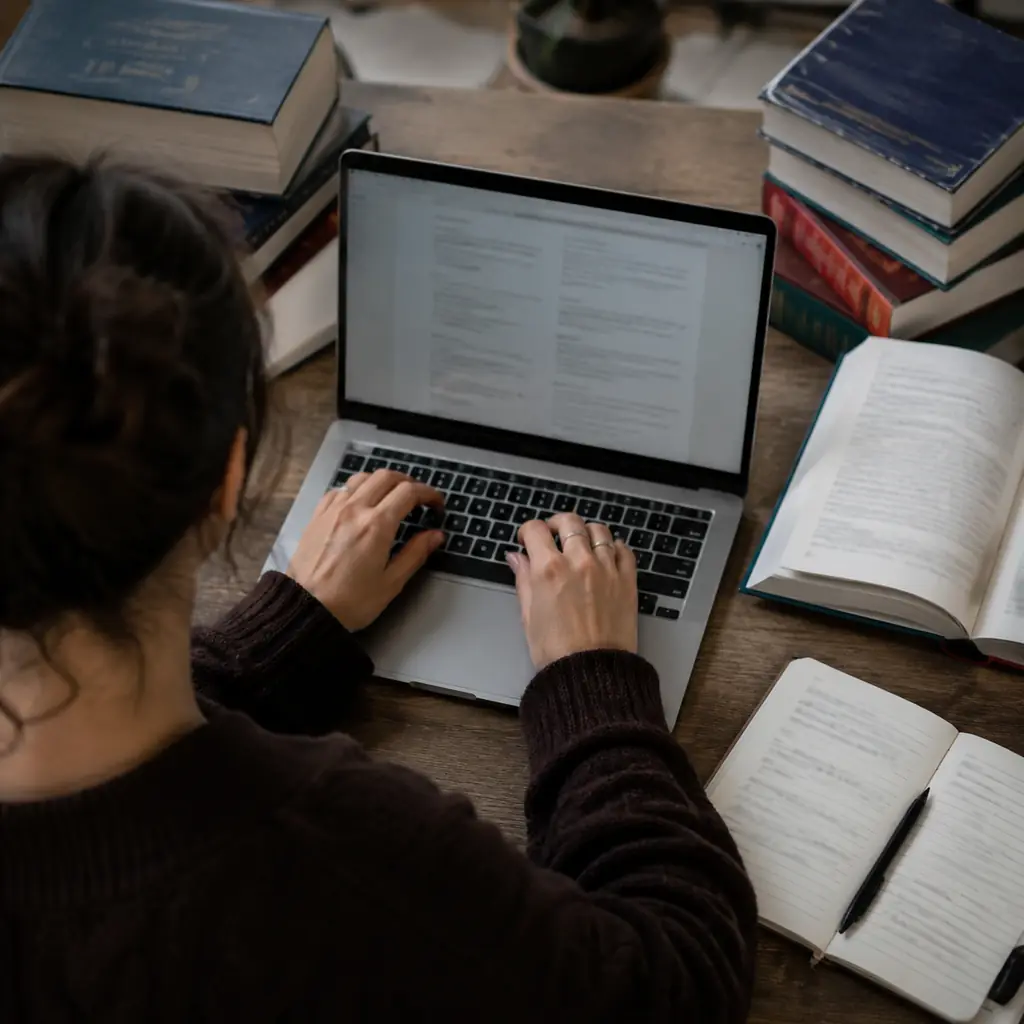 Multilingual writer typing accented letters on a laptop