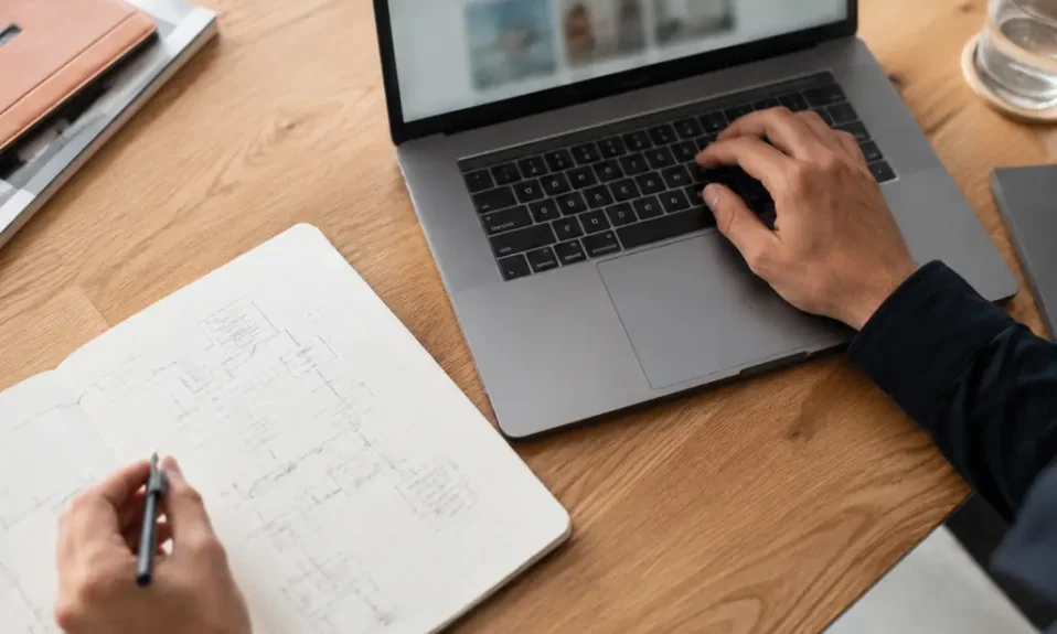 Designer using arrow symbols while working on a laptop